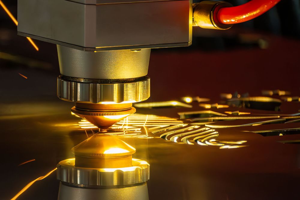 The fiber laser's cutting head over a steel sheet